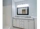 This bathroom has a double vanity with granite countertop and black trimmed mirror at 733 Wesley Chapel Rd, Villa Rica, GA 30180