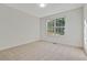 Simple bedroom with neutral carpet, and large window providing natural light at 733 Wesley Chapel Rd, Villa Rica, GA 30180