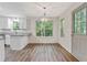 Dining room featuring natural light, wood-look floors, and an elegant chandelier at 733 Wesley Chapel Rd, Villa Rica, GA 30180