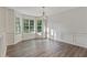 Bright dining room features beautiful floors, wainscoting and a bay window providing natural light at 733 Wesley Chapel Rd, Villa Rica, GA 30180