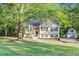 Quaint home with a lush front yard, a charming gazebo, and a storage shed at 733 Wesley Chapel Rd, Villa Rica, GA 30180