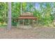 Inviting wooden gazebo nestled among the trees provides a peaceful retreat in the backyard at 733 Wesley Chapel Rd, Villa Rica, GA 30180