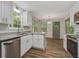 Renovated kitchen featuring granite counters, stainless appliances, and wood-look flooring at 733 Wesley Chapel Rd, Villa Rica, GA 30180