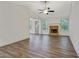 Open concept living room featuring wood look floors, fireplace, and multiple windows at 733 Wesley Chapel Rd, Villa Rica, GA 30180