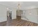 Open-concept living area with hardwood floors, modern chandelier and a view of the kitchen at 733 Wesley Chapel Rd, Villa Rica, GA 30180