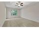 Spacious main bedroom featuring a tray ceiling, ceiling fan, and a large window at 733 Wesley Chapel Rd, Villa Rica, GA 30180