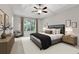 Staged main bedroom with tray ceiling, ceiling fan, large window and stylish decor at 733 Wesley Chapel Rd, Villa Rica, GA 30180