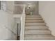 View of the carpeted stairs with white railing leading to second floor at 733 Wesley Chapel Rd, Villa Rica, GA 30180