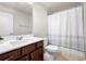 Neutral bathroom featuring a bath with a white shower curtain and a light countertop with brown cabinets at 774 Belrose Dr, Smyrna, GA 30080