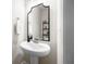 Cozy half bathroom featuring a pedestal sink, large mirror and modern fixtures at 774 Belrose Dr, Smyrna, GA 30080