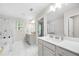 Bright main bathroom featuring dual sinks, a soaking tub, and a walk-in shower at 774 Belrose Dr, Smyrna, GA 30080