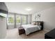 Bright bedroom with natural light, neutral carpet, television, and a cozy queen-sized bed with decorative pillows at 774 Belrose Dr, Smyrna, GA 30080