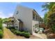 A townhouse exterior featuring a private patio, landscaping, and outdoor living spaces at 774 Belrose Dr, Smyrna, GA 30080