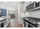 Well-lit kitchen featuring stainless steel appliances, a white subway tile backsplash, and an island at 774 Belrose Dr, Smyrna, GA 30080