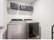 A spacious laundry room featuring modern side-by-side washing machine and dryer at 774 Belrose Dr, Smyrna, GA 30080