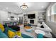 Modern living room featuring a fireplace with a TV, and a kitchen in the background at 774 Belrose Dr, Smyrna, GA 30080