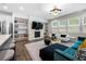 Bright open-concept living space with a fireplace, built-in shelves, and modern furnishings at 774 Belrose Dr, Smyrna, GA 30080