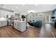 Open-concept living space with a white kitchen, modern furnishings, and wood flooring at 774 Belrose Dr, Smyrna, GA 30080