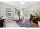 Inviting home office featuring a white board, a modern rug, desk, white chairs, and private balcony access at 774 Belrose Dr, Smyrna, GA 30080