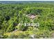 Aerial view of sprawling property featuring a private home with lush landscaping and mature trees at 1572 Azalea Dr, Lawrenceville, GA 30043