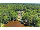 Aerial view of the pool and lake with trees all around at 1572 Azalea Dr, Lawrenceville, GA 30043