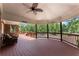Spacious back porch with wood flooring and a ceiling fan overlooking the trees at 1572 Azalea Dr, Lawrenceville, GA 30043