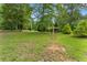 Picturesque backyard featuring a disc golf basket amongst the trees at 1572 Azalea Dr, Lawrenceville, GA 30043