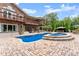 Spacious backyard oasis boasts a pool, spa, covered patio, and lush landscaping for ultimate privacy at 1572 Azalea Dr, Lawrenceville, GA 30043