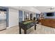 Finished basement featuring a foosball table and multiple seating areas with tiled floors at 1572 Azalea Dr, Lawrenceville, GA 30043