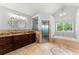 Bright bathroom features a soaking tub, glass shower, and granite vanity with decorative mirror at 1572 Azalea Dr, Lawrenceville, GA 30043