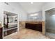 Bathroom with granite vanity, glass enclosed shower and access to the main bedroom at 1572 Azalea Dr, Lawrenceville, GA 30043