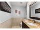 Powder room featuring elegant fixtures, granite countertop, and decorative accents at 1572 Azalea Dr, Lawrenceville, GA 30043