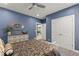 Beautiful bedroom with patterned bedding, carpet, ceiling fan, and an ensuite bathroom at 1572 Azalea Dr, Lawrenceville, GA 30043