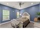 Comfortable bedroom with a cozy bed, ceiling fan, and carpet flooring at 1572 Azalea Dr, Lawrenceville, GA 30043