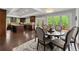 Dining area with view of deck, adjacent to kitchen, with dark wood floors at 1572 Azalea Dr, Lawrenceville, GA 30043