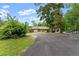 Charming home featuring an attached two-car garage, a welcoming front porch, and a long driveway at 1572 Azalea Dr, Lawrenceville, GA 30043
