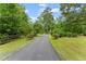Long paved driveway leads to a private home surrounded by lush greenery at 1572 Azalea Dr, Lawrenceville, GA 30043