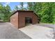 A steel garage with a concrete drive and gravel surrounding it at 1572 Azalea Dr, Lawrenceville, GA 30043