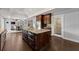 Kitchen island with granite countertop and dark wood cabinets at 1572 Azalea Dr, Lawrenceville, GA 30043