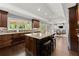 Spacious kitchen with granite countertops, dark wood cabinets, and a kitchen island at 1572 Azalea Dr, Lawrenceville, GA 30043
