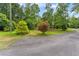 Well manicured yard with mature trees and decorative landscaping at 1572 Azalea Dr, Lawrenceville, GA 30043