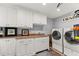 Well-organized laundry room with white cabinetry, granite countertops, and modern washer and dryer at 1572 Azalea Dr, Lawrenceville, GA 30043
