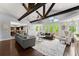 Bright living room with large windows and exposed beams, adjoining the kitchen at 1572 Azalea Dr, Lawrenceville, GA 30043