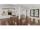 Spacious living room featuring hardwood floors, a fireplace with built-in shelving, and elegant columns at 1572 Azalea Dr, Lawrenceville, GA 30043