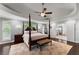 A beautiful main bedroom featuring trey ceilings, a ceiling fan, and a four-poster bed at 1572 Azalea Dr, Lawrenceville, GA 30043