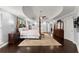 Spacious main bedroom with tray ceiling, dark wood floors, and sitting area at 1572 Azalea Dr, Lawrenceville, GA 30043