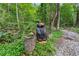 A black bear statue sits in the tree line at 1572 Azalea Dr, Lawrenceville, GA 30043