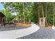 Landscaped path with swing bench and a target lead to the home at 1572 Azalea Dr, Lawrenceville, GA 30043