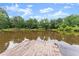 Scenic view of the pond, featuring the wooden dock on the property at 1572 Azalea Dr, Lawrenceville, GA 30043