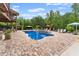 Gorgeous backyard features a large pool, stone patio, and multiple seating areas perfect for entertaining at 1572 Azalea Dr, Lawrenceville, GA 30043